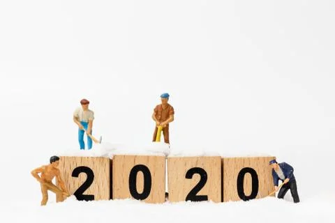 Miniature people : Worker team create wooden block number 2020 Stock Photos