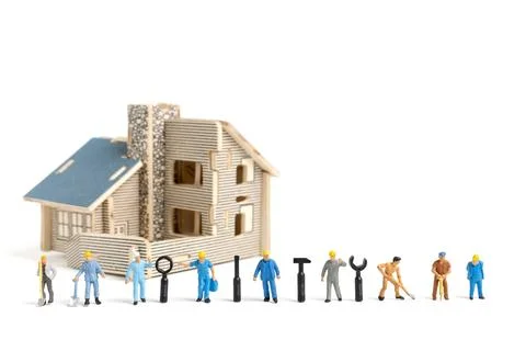 Miniature people : Worker team with tools supplies for repair house on whit.. Stock Photos