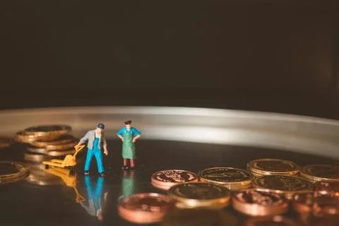 Miniature people, workers lifting stack coins Stock Photos