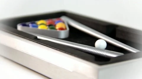 Miniature pool table with balls and sticks on white background Stock Footage 12341851