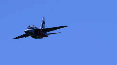 Miniature RC Plane Leonardo M-346 Banking Flyby Blue Sky Tracking Shot Stock Footage 334293688