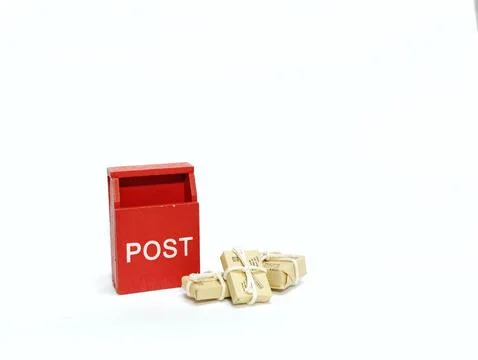 Miniature Red Post Box with Tiny Parcels on White Background 스톡 사진