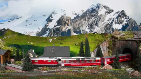 Miniature red train. Model railway. Mountain ambientation Stock Footage 232426390