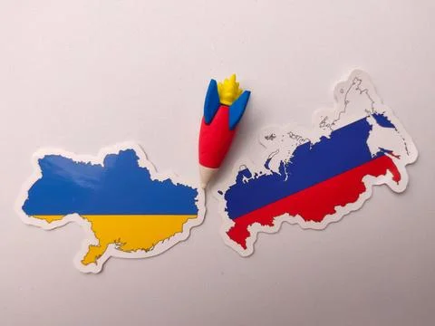 Miniature rocket figurine placed between two map sticker map of Ukraine and.. Stock Photos