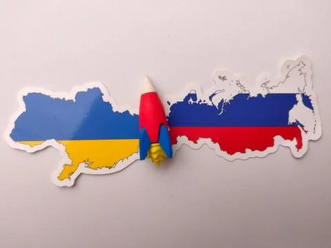 Miniature rocket figurine placed between two map sticker map of Ukraine and.. Stock Photos