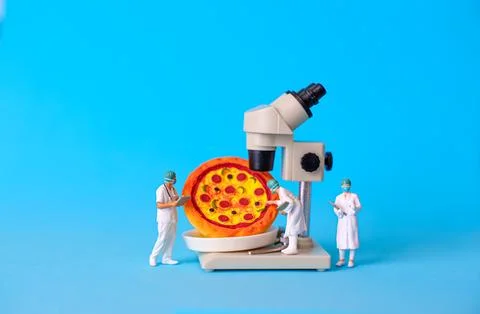 Miniature Scientists Analyzing Pizza with Microscope for Food Quality Control Photos