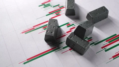 Miniature silver bars and charts of stock fluctuations. Stockbeeldmateriaal 233462425