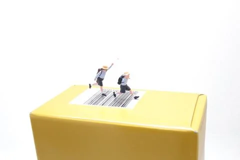 Miniature students run energetically across yellow barcode package Stock Photos