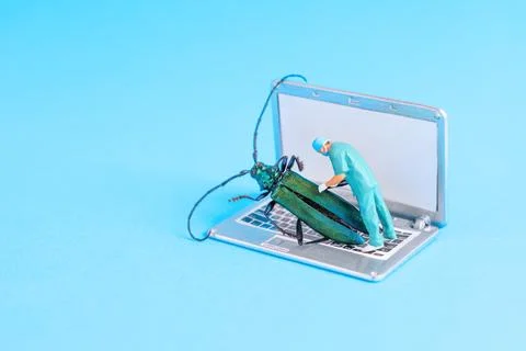 Miniature Surgeon Removing Malware Bug From Laptop's Keyboard in Bright Setti Stock Photos