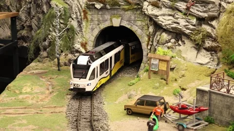 Miniature Train Emerging From A Mountain Tunnel In A Detailed Diorama Scene Video stock 302567521