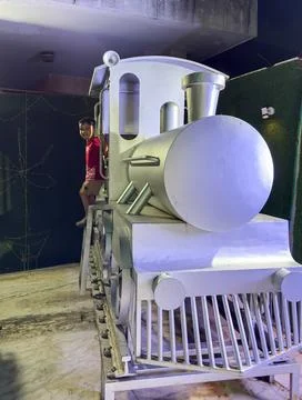 Miniature Train Engine with Happy Young Boy at gate At Indoor Family Entert.. Stock Photos