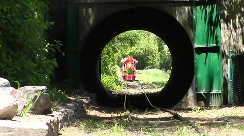 Miniature train rolling through tunnel 動画素材 60775879