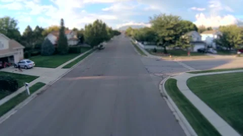Miniature view flying down suburban neighborhood Stock Footage 44349248