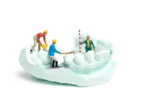 Miniature Worker team is filing fake teeth Stock Photos