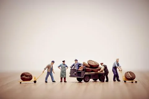 Miniature workers loading coffee beans on truck Stock Photos