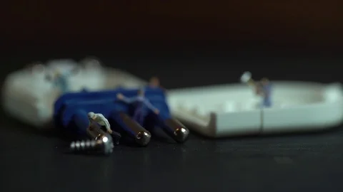 Miniature workers work inside an electric plug 스톡 동영상 127169352
