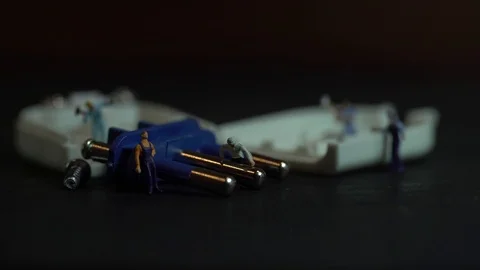 Miniature workers work inside an electric plug 스톡 동영상 127169359