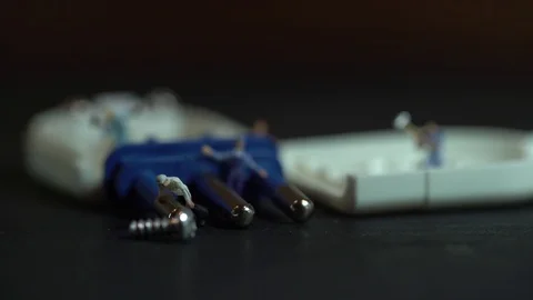 Miniature workers work inside an electric plug Stock Footage 127169395