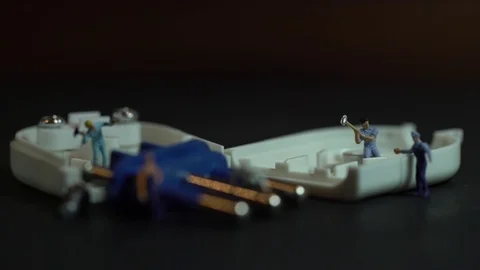 Miniature workers work inside an electric plug Stock Footage 127169396