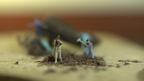 Miniature workers work on a piece of chocolate Stock Footage 127169061
