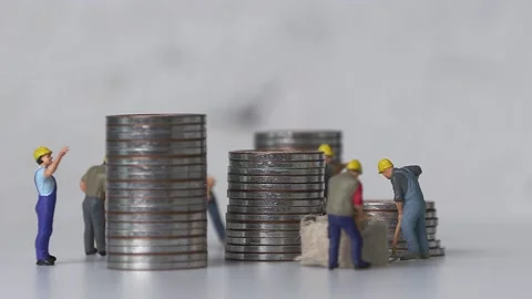 Miniature workers working and piles of coins. Stock Footage 231957194