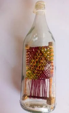 Miniature woven charpai cot inside glass bottle craft Stock Photos