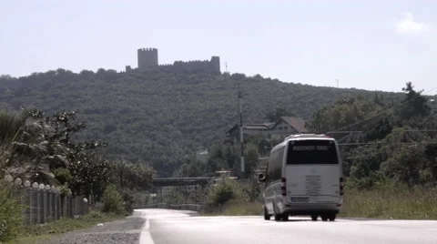 Minibus going with speed on a paved road built at base of a wooded hill on wh Stock Footage 61781722