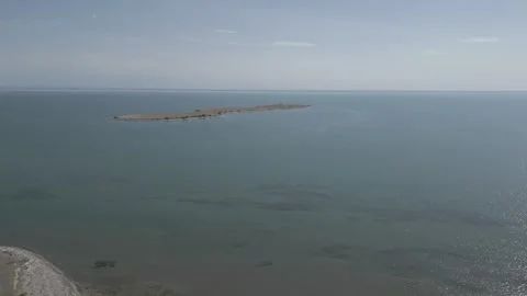 Minimal Aerial View of Remote Island Surrounded by Water Stock Footage 343074687