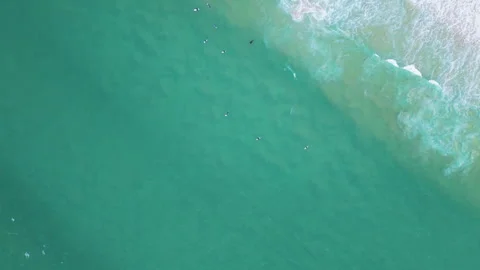 Minimal aerial view of surfers floating in calm turquoise ocean water Видео 321978241