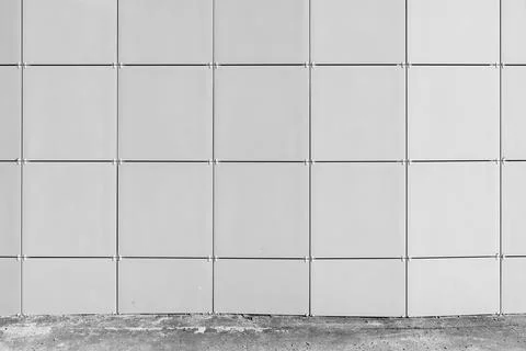 Minimal architectural facade showing a grid of square metal panels with vis.. Stock Photos