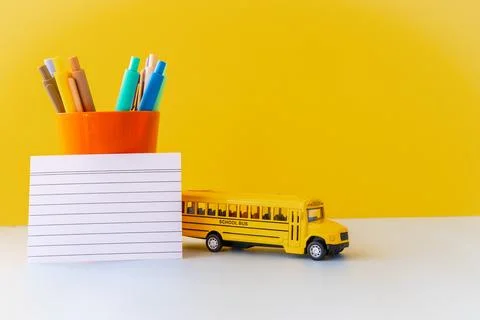 Minimal back to school composition with yellow school bus colorful pens in .. Stock Photos