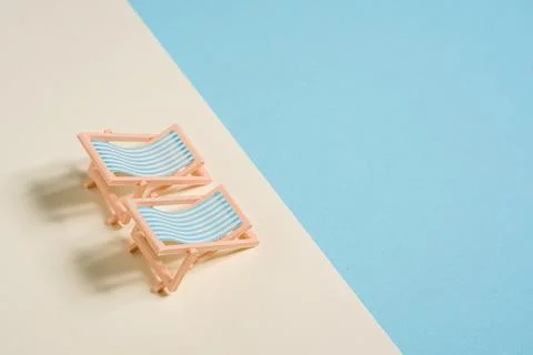 Minimal beach chairs representing summer vacation relaxation and leisure li.. Stock Photos