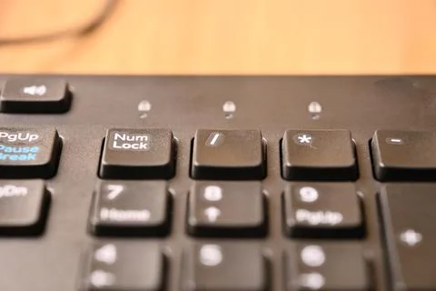 Minimal Black Keyboard Macro Composition Highlighting Slash Key on Numeric .. Stock Photos