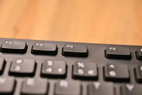 Minimal Black Keyboard Macro Composition Highlighting F4 Function Key in So.. Stock Photos