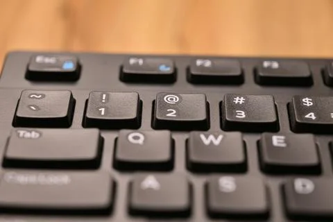 Minimal Black Keyboard Macro Composition Highlighting 2 and At Symbol Key i.. Stock Photos