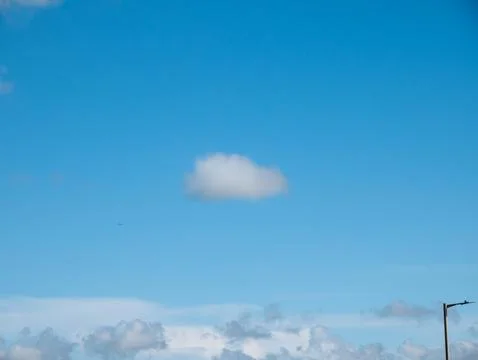 Minimal blue sky with single cloud 스톡 사진