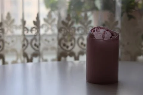 Minimal candle on white table with soft blurred curtain background Stock Photos