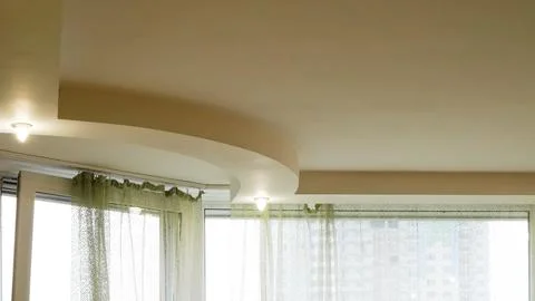 Minimal ceiling lights in modern interior with white walls and soft glow 写真素材