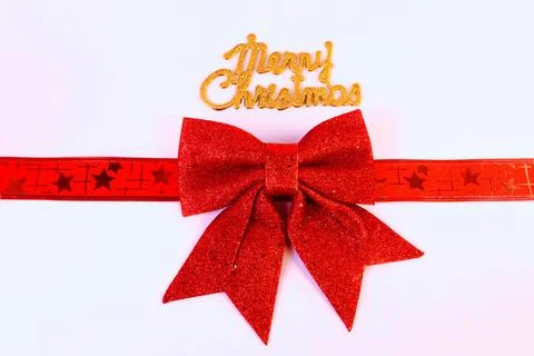 Minimal Christmas background featuring a red glitter bow with decorative ribbon Stock Photos