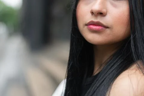 Minimal close up portrait focused on lips and lower face of a young Latina .. Stock Photos
