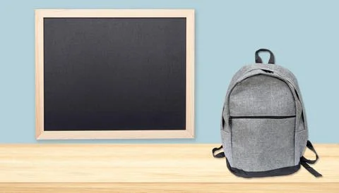 Minimal composition of chalkboard, tabletop with free space and backpack Stock Photos