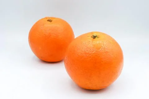 Minimal composition featuring two whole oranges side-by-side Stock Photos