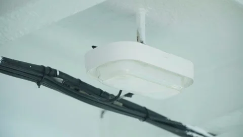 Minimal corridor lighting with conduit and plastic casing detail. Interior Stock Footage 333571142