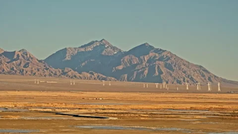 Minimal desert landscape with distant power transmission towers Stock Footage 326239939