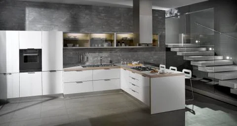 Minimal design white kitchen in a grey interior with staircase 02 Stock Photos