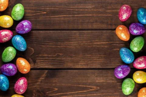 Minimal easter concept with colored easter eggs as a frame. Wooden background 写真素材