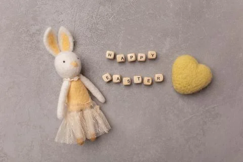 Minimal Easter concept. Easter bunny and yellow heart with text Happy Easter Stock Photos