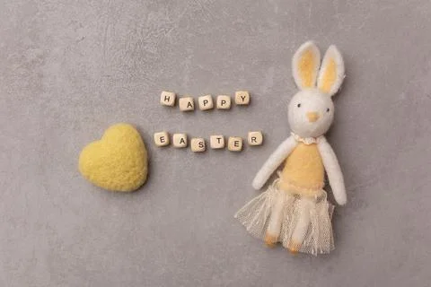 Minimal Easter concept. Easter bunny and yellow heart with text Happy Easter Stock Photos