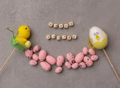 Minimal Easter concept. Pink eggs and easter decor with text Happy Easter Stock Photos