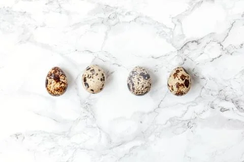 Minimal easter decoration with eggs on white marble background 스톡 사진